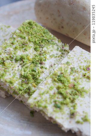 Indulge in delightful Indian sweets adorned with a scrumptious pistachio topping 119835245