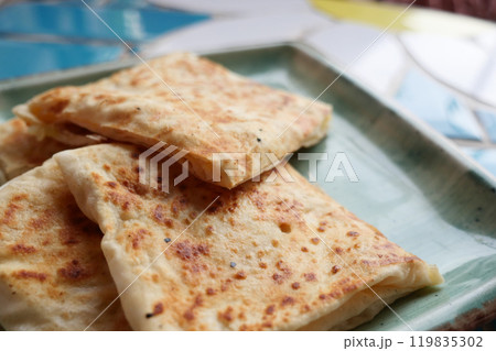 This exquisite and delicious golden brown flatbread is beautifully served on a lovely plate 119835302