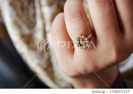 This is an Elegant Gold Ring featuring exquisite Gemstone Accents set on a Delicate Hand 119835337
