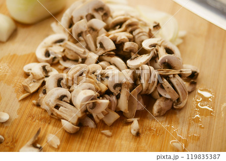 Chopped Fresh Mushrooms Placed on a Rustic Wooden Cutting Board for Various Culinary Creations Chopped Fresh Mushrooms Placed on a Rustic Wooden Cutting Board for Various Culinary Creations 119835387