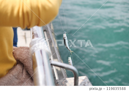 Fishing Adventure A Memorable Catch at the Tranquil Waters Edge During Leisure Time Fishing Adventure A Memorable Catch at the Tranquil Waters Edge During Leisure Time 119835588