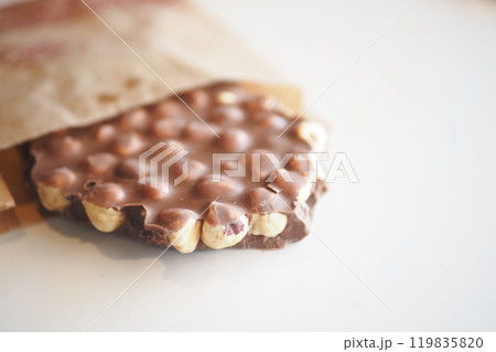 Delicious Chocolate Coated Snack Bar Featuring Nuts and a Delightfully Crispy Texture 119835820