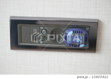 Close-Up of Electric Plug with Insect Repellent Device Close-Up of Electric Plug with Insect Repellent Device 119835822