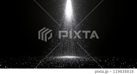 A beam of light shines down through a shower of sparkling particles. A beam of light shines down through a shower of sparkling particles. 119838818