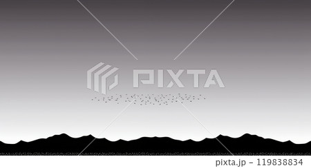 Silhouettes of mountains and a flock of birds against a gray sky. 119838834