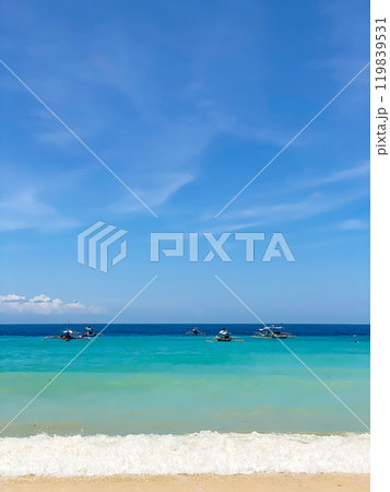 Fishing boats over the sea surface. Ocean waves on beach resort. Samal Island. Davao, Philippines. 119839531