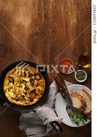 Healthy breakfast, omelette with fried seasonal forest mushrooms Chanterelles in frying pan on a wooden background with plate and cutlery, top view, copy space Healthy breakfast, omelette with fried seasonal forest mushrooms Chanterelles in frying pan on a wooden background with plate and cutlery, top view, copy space 119843607