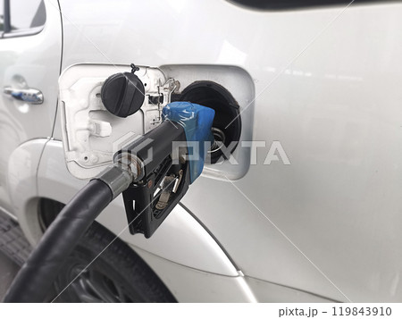 Refueling Car fill with petrol gasoline at gas station and Petrol pump filling fuel nozzle in fuel tank of car Refueling Car fill with petrol gasoline at gas station and Petrol pump filling fuel nozzle in fuel tank of car 119843910