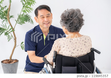 車いすのシニア女性と男性介護士 119845357
