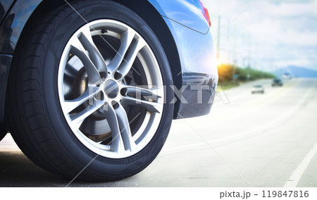 Close up of a grey luxury wheel of car parked on an open road Close up of a grey luxury wheel of car parked on an open road 119847816
