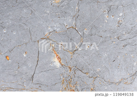 Rough gray stone surface with natural cracks and grey tones. Ideal as a background for websites Rough gray stone surface with natural cracks and grey tones. Ideal as a background for websites 119849138