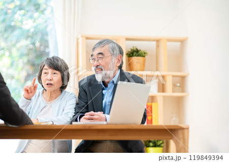 シニア夫婦に説明する営業マン　遺産相続について相談するシニア夫婦 119849394