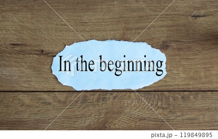 Words 'in the beginning' on the piece of paper. 119849895