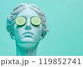 Statue of a Greek goddess with cucumber slices on eyes. Sculpture on spa treatments after bath. Beauty procedures, self-care, art, wellness, cosmetics and beauty salon, relaxation concept 119852741
