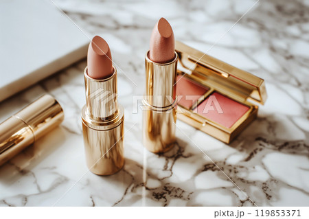 Decorative cosmetics in gold color packaging. Golden makeup products. Professional makeup products for fashion blogger. lipstick, blush and eyeshadow. 119853371