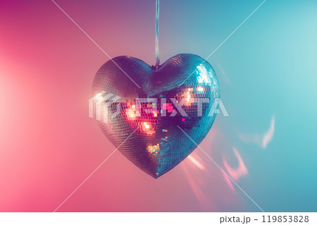 Heart shaped disco ball. Valentine's Day, love symbol and romantic exclusive relationships concept. Party decorations and dancing in nightclub theme. Heart-shaped discoball hanging from the ceiling 119853828