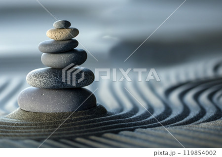 Zen garden wallpaper. Tranquil japanese Zen garden with stones in textured sand. Pebble stone balanced tower minimalist background with copy space. Meditation, mindfulness, harmony and balance concept 119854002