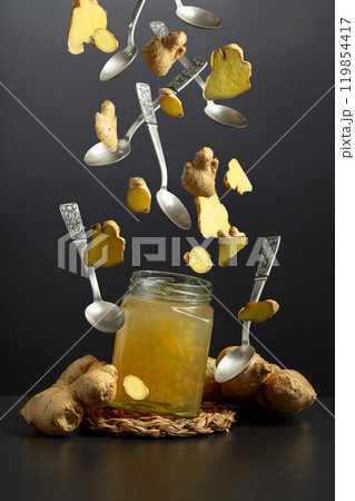 Ginger jam and fresh ginger on a black background. Ginger jam and fresh ginger on a black background. 119854417