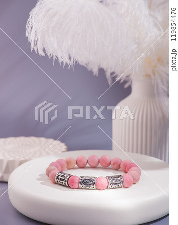 Woman's wrist wearing orange agate bracelet, isolated on white background. Woman's wrist wearing orange agate bracelet, isolated on white background. 119854476