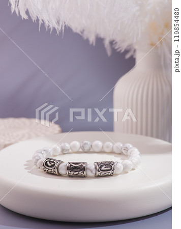 Woman's wrist wearing orange agate bracelet, isolated on white background. Woman's wrist wearing orange agate bracelet, isolated on white background. 119854480