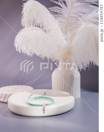 Woman's wrist wearing orange agate bracelet, isolated on white background. Woman's wrist wearing orange agate bracelet, isolated on white background. 119854787