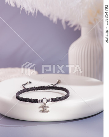 Woman's wrist wearing orange agate bracelet, isolated on white background. 119854792