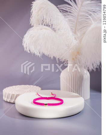 Woman's wrist wearing orange agate bracelet, isolated on white background. 119854799