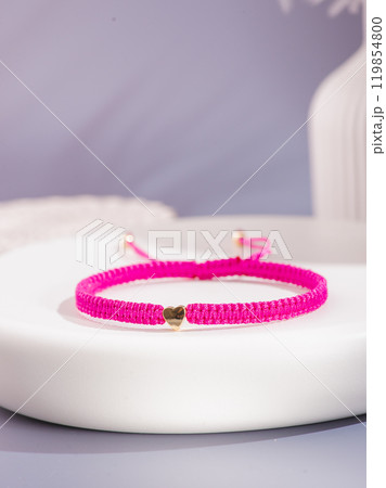 Woman's wrist wearing orange agate bracelet, isolated on white background. 119854800