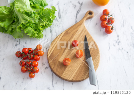 cherry tomatoes on a cutting board before slicing cherry tomatoes on a cutting board before slicing 119855120