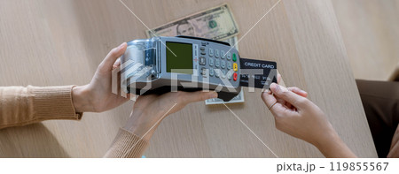 Customer using credit card for payment to receptionist. cashless technology and credit card payment concept. Owner In Retail Shop With Customer Paying Using Payment Credit Card Customer using credit card for payment to receptionist. cashless technology and credit card payment concept. Owner In Retail Shop With Customer Paying Using Payment Credit Card 119855567