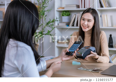 QR code payment, customer using smartphone for paying at shop. Customer paying with qr code on smartphone screen payment technology at shop QR code payment, customer using smartphone for paying at shop. Customer paying with qr code on smartphone screen payment technology at shop 119855577