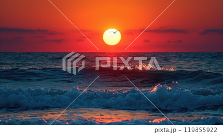 The sun is setting over the ocean, casting a warm glow on the water 119855922