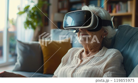 Serene Senior Woman Engaging with Virtual Reality Experience in Contemporary Living Room. Serene Senior Woman Engaging with Virtual Reality Experience in Contemporary Living Room. 119855975