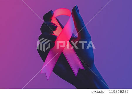 Glowing Pink Ribbon in a Hand Against a Colorful Background Glowing Pink Ribbon in a Hand Against a Colorful Background 119856285