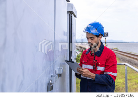Electrical engineer man checking Power at Contruction Site. electrical engineer inspect the electrical systems at the equipment site Electrical engineer man checking Power at Contruction Site. electrical engineer inspect the electrical systems at the equipment site 119857166