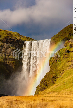 Skogafoss waterfall and rainbow at sunny autumn day, Iceland. Great tourist attraction, Skogafoss waterfall and rainbow at sunny autumn day, Iceland. Great tourist attraction, 119857209