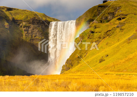 Skogafoss waterfall and rainbow at sunny autumn day, Iceland. Great tourist attraction, Skogafoss waterfall and rainbow at sunny autumn day, Iceland. Great tourist attraction, 119857210