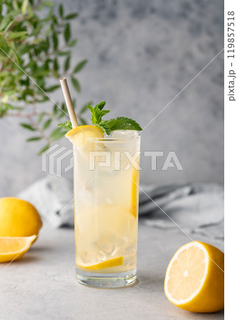 Freshness mojito drink with lemon, mint and ice. Citrus lemonade on a blue background with napkin 119857518