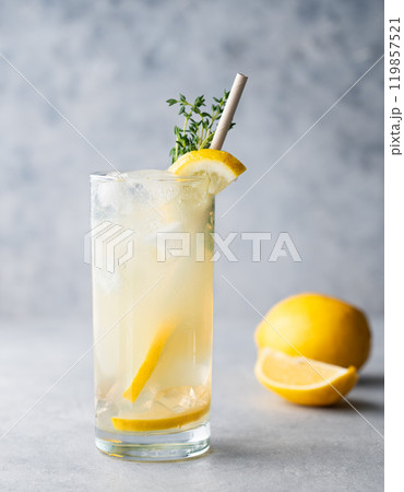 Freshness mojito drink with lemon, mint and ice. Citrus lemonade on a blue background and fruits Freshness mojito drink with lemon, mint and ice. Citrus lemonade on a blue background and fruits 119857521
