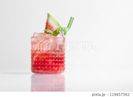 Glass of refreshing watermelon smoothie with basil, ice on white isolated background with shadow Glass of refreshing watermelon smoothie with basil, ice on white isolated background with shadow 119857562