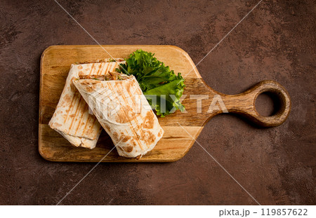 cut shawarma, 2 pieces, on a cutting board, close-up, 119857622