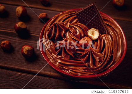 Chocolate nut paste, mousse, pasta, in a cup, on a wooden table, top view, selective focus, no people, 119857635