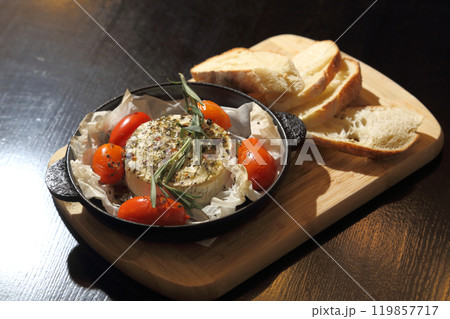 Grilled Camembert. Grilled Camembert cheese with tomatoes and bread. 119857717