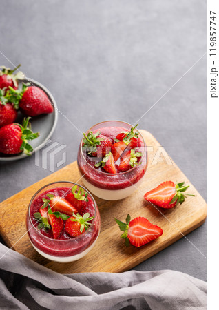 Panna cotta with strawberry and cream in glasses with fresh berries on a wooden board Panna cotta with strawberry and cream in glasses with fresh berries on a wooden board 119857747