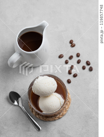 Affogato coffee with vanilla ice cream scoops and espresso in a glass on a light background Affogato coffee with vanilla ice cream scoops and espresso in a glass on a light background 119857748
