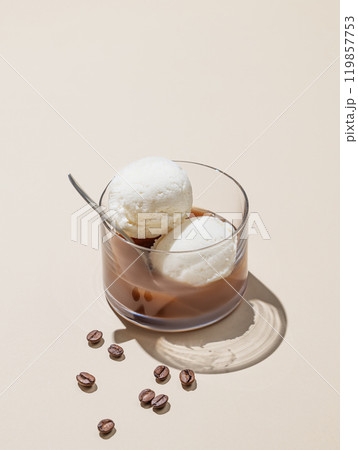 Affogato coffee with vanilla ice cream scoops and espresso in a glass on a yellow background Affogato coffee with vanilla ice cream scoops and espresso in a glass on a yellow background 119857753
