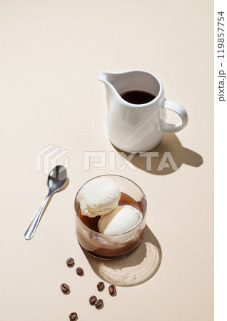 Affogato coffee with vanilla ice cream scoops and espresso in a glass on a yellow background Affogato coffee with vanilla ice cream scoops and espresso in a glass on a yellow background 119857754