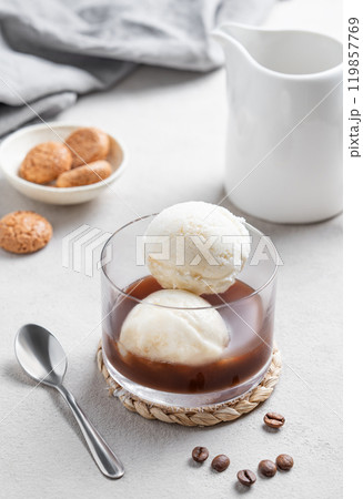 Affogato coffee with vanilla ice cream scoops and espresso in a glass on a light background Affogato coffee with vanilla ice cream scoops and espresso in a glass on a light background 119857769