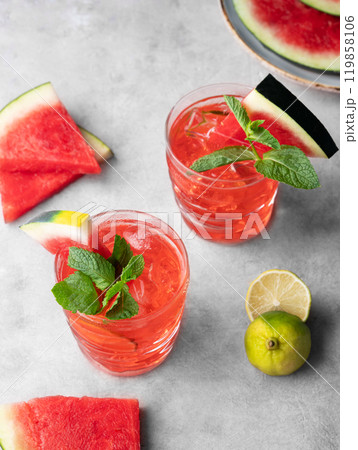 Flat lay of mojito cocktail with watermelon, lime, ice and mint in a two glasses Flat lay of mojito cocktail with watermelon, lime, ice and mint in a two glasses 119858106
