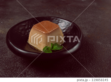 cream caramel pudding, with caramel sauce, dessert,breakfast, on a black plate, mint, no people, 119858145